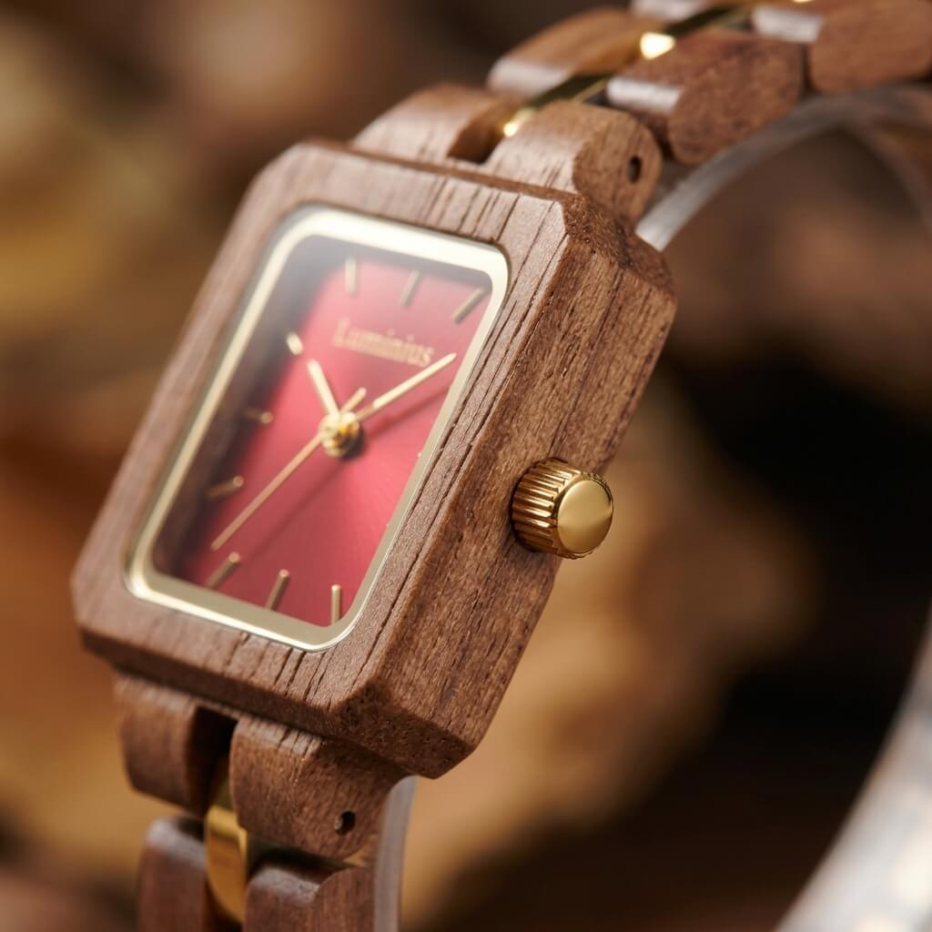 Close-up of The Cherry's sparkling cherry square dial and walnut case