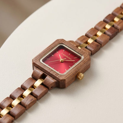 The Cherry lightweight wood watch laid flat on a cream surface