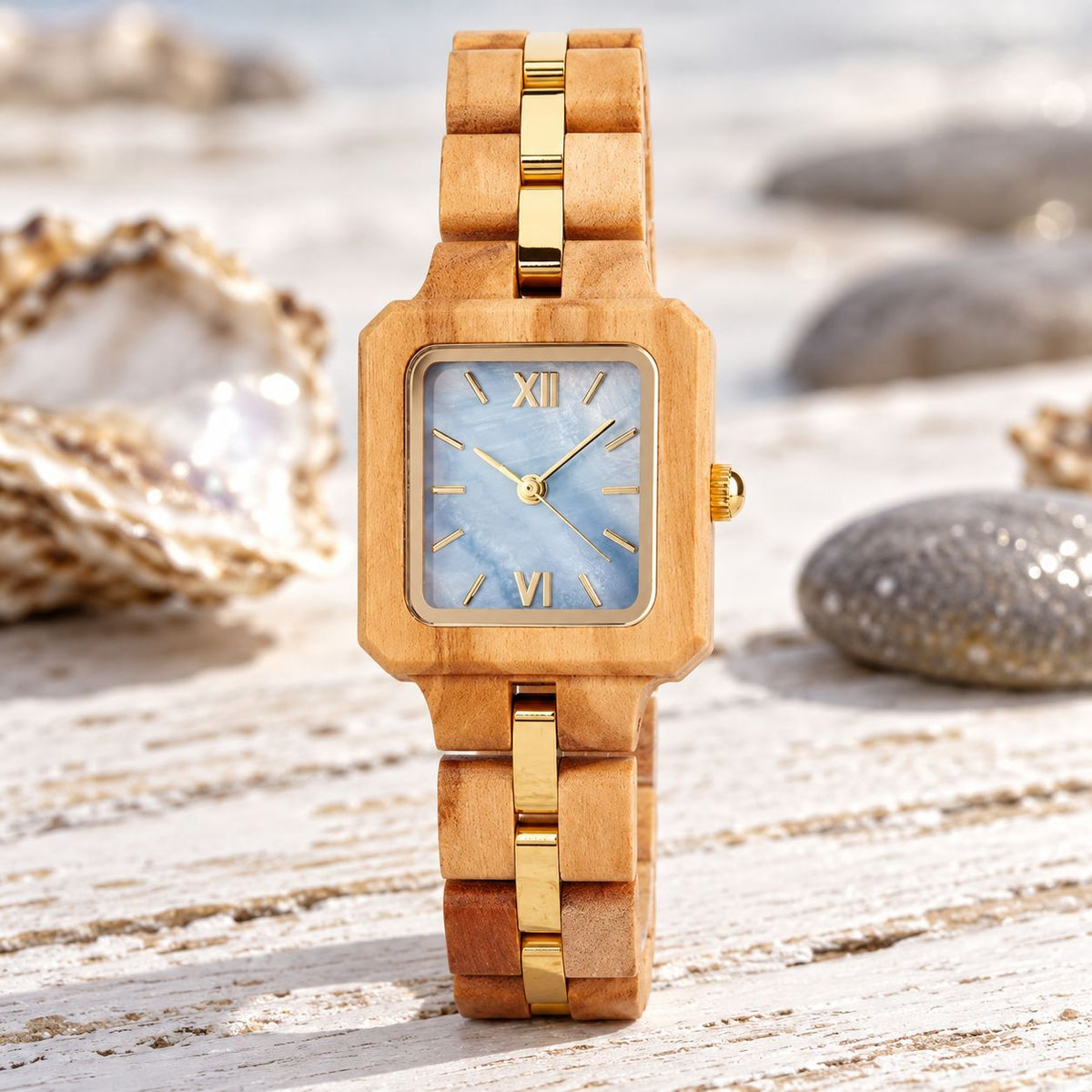 The Blue Pearl women's olive wood watch standing among oyster shells and pebbles