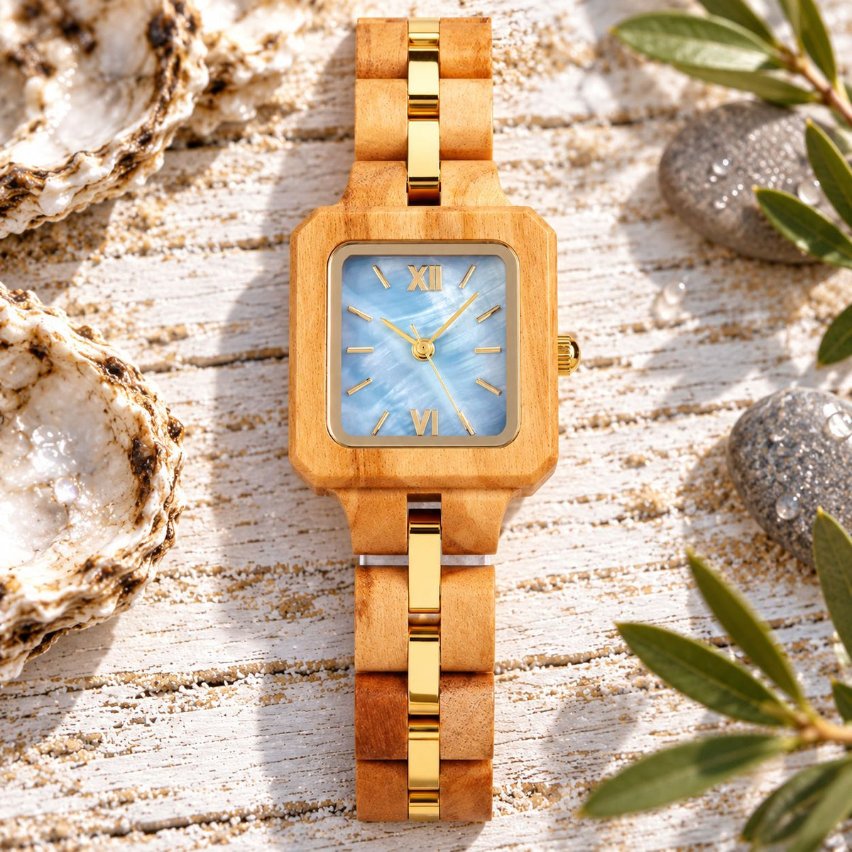 Front view of The Blue Pearl olive wood watch with gold-tinted links and oyster shells