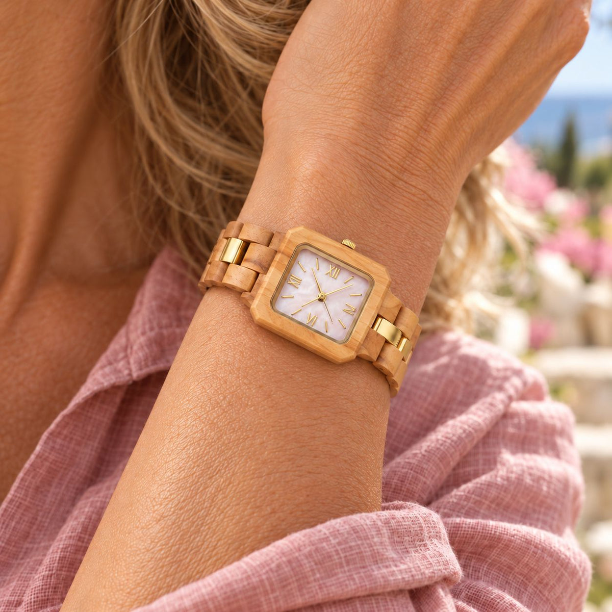 Woman in a pink linen shirt wearing The Pink Pearl slim wood watch